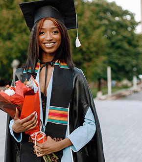 Graduate holding a red-wrapped bouquet