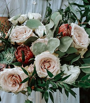 Blush rose arrangement with eucalyptus and protea