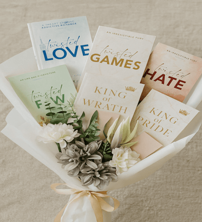 Books and white flowers arranged as a gift bouquet