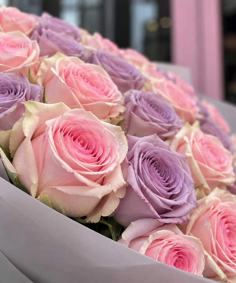 Pink and purple rose bouquet with light pink and lavender blooms, close-up