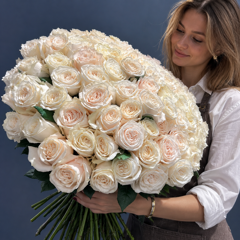 Large white rose bouquet with green leaves and exposed stems, side view